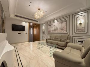 a living room with couches and a glass table at Hotel Plaza 14 Jammu, Near Railway Station in Jammu