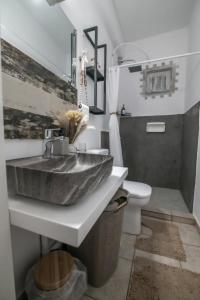 a bathroom with a sink and a toilet at Taygetos Escape Sparta in Perivólia