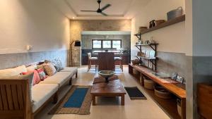 a living room with a couch and a table at Villa Brahmari in Ubud