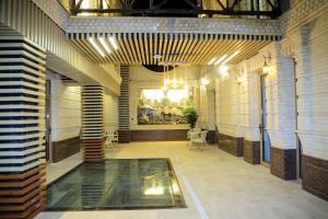 a room with a pool in the middle of a building at Rich Land Hotel in Samarkand