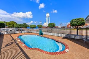 a swimming pool with a clock tower in the background at Days Inn by Wyndham Lexington in Lexington