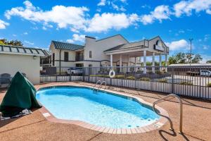 a swimming pool in front of a house at Days Inn by Wyndham Lexington in Lexington