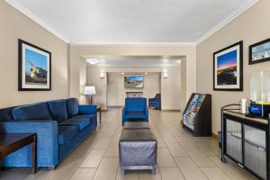 a living room with a blue couch and a table at Comfort Inn & Suites Lancaster Antelope Valley in Lancaster
