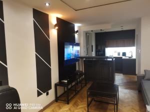 a living room with a tv on a wall at Super studio w centrum miasta Hoza 9a in Otwock