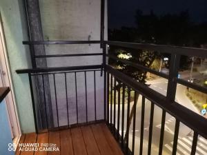 a balcony with a black railing with a view of a street at Super studio w centrum miasta Hoza 9a in Otwock