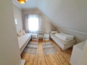 a small room with two beds and a window at 6 person holiday home in Finnsnes-By Traum in Finnsnes