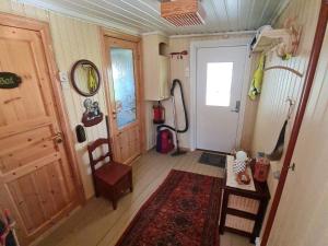 a room with a hallway with a door and a rug at 6 person holiday home in Finnsnes-By Traum in Finnsnes