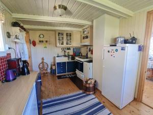 a kitchen with a white refrigerator in a room at 6 person holiday home in Finnsnes-By Traum in Finnsnes +27 photos