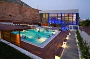 a group of people in a swimming pool in a building at Loutraki Getaway - Cozy and Quiet Nest in Loutraki