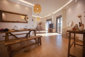 a living room with a table and a mirror at Akl - Chic Apartments & Balconies in Batroun in Batroûn