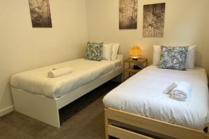 two beds in a room with towels on them at Timeless Tranmere Escape By Host Solutions in Norwood