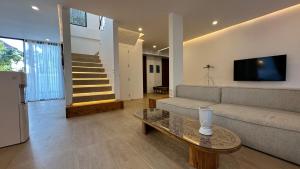 a living room with a couch and a table at Dreamland View Villa #3 with Pool in Uluwatu