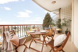 a patio with a table and chairs on a balcony at Akl - Chic Apartments & Balconies in Batroun in Batroûn