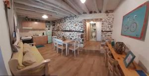 a kitchen and dining room with a stone wall at Kunada home in Potamiá
