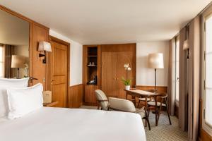 a hotel room with a bed and a table and chairs at Hôtel Villa Madame - Saint-Germain-des-Prés in Paris