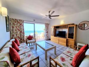 a living room with a couch and a table at Shaka's Rock Sea Vista - 17 Siesta in Ballito