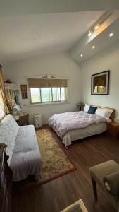 a large bedroom with two beds and a window at May的家民宿 in Suao