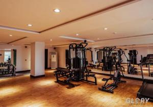 a gym with several treadmills and elliptical machines at 1-BHK Designer Black at Zameen Opal in Lahore