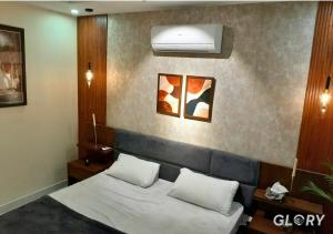 a bedroom with a bed with two pillows at 1-BHK Designer Black at Zameen Opal in Lahore +10 photos