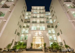 an apartment building at night with a lit up entrance at 1-BHK Designer Black at Zameen Opal in Lahore