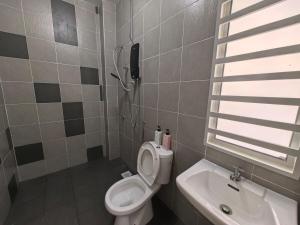 a small bathroom with a toilet and a sink at Padang Serai Taman Ria 61 in Padang Serai
