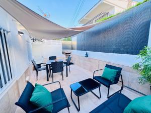 a patio with blue chairs and a table and chairs at Leo Apartamentos La Cova in Peniscola