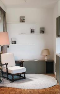 a living room with a chair and a rug at Guesthouse am See LOOM in Plescherken