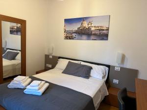 a bedroom with a bed with towels on it at Osteria Locanda Veneta in Mirano