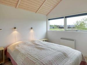 a bedroom with a bed and a large window at Luxury Spa Retreat by Skaven - By Traum Ferienwohnungen in Hemmet +21 photos