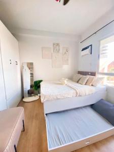 a bedroom with two beds and a couch at Cozy Mesatierra Garden by Adi Staycation Dvo in Davao City
