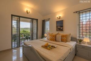 a bedroom with a bed with a tray of food on it at EKOSTAY - Villa Eve in Ooty