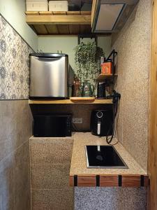 a kitchen with a sink and a refrigerator at Dona Remedios in Xermade