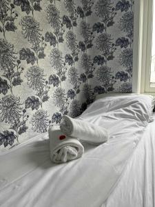 a white towel on a bed in a bedroom at KB Storhaugen House - Sørvågen in Moskenes +51 photos