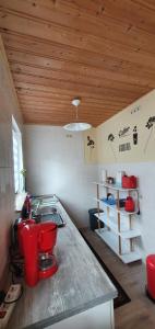 a kitchen with a counter with red chairs in it at Ferienwohnung im Herzen des Pfälzer Waldes in Elmstein