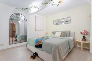 a white bedroom with a bed and a mirror at L'Escale - Idéal Couple & Pro en Quête d'un Moment Détente et se Ressourcer - Sauna Exclusif & Terrasse Privée - Piscine - WIFI HD - 5min Port Toulon & Plage in Toulon +27 photos
