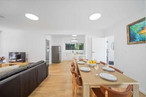 a dining room and living room with a table and chairs at The Palms in Coolum Beach - Unit B in Coolum Beach