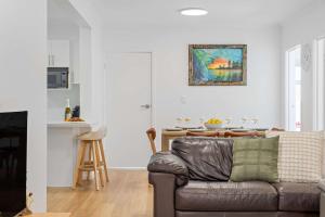 a living room with a couch and a table at The Palms in Coolum Beach - Unit B in Coolum Beach