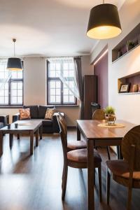a living room with a table and a couch at NiceOne Apartment Number 10 - W samym Centrum! in Wrocław