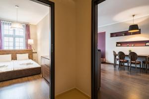 a bedroom with a bed and a dining room at NiceOne Apartment Number 10 - W samym Centrum! in Wrocław