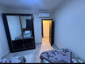 a room with a mirror and a bed in it at Aqwa view in El Alamein