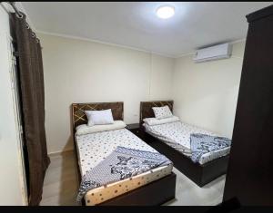 a small room with two beds in it at Aqwa view in El Alamein