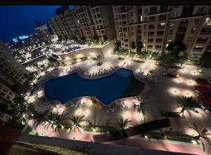 an aerial view of a large swimming pool at night at Aqwa view in El Alamein