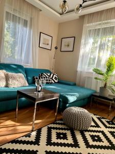 バラトンセメッシュにあるRemora Apartman Balatonszemesの緑のソファとテーブルのあるリビングルーム