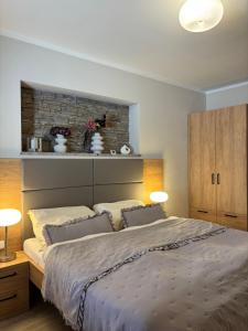 a bedroom with a large bed with two pillows at Penzion Apartmány Resident in Poděbrady