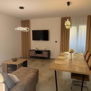 a living room with a table and a couch at Pet-house in Trstice