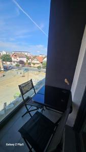 a bird sitting on a table and a chair on a balcony at Apartman Mima in Inđija +6 photos