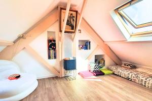 a attic room with a skylight and a bed at Spacious cocoon near the sea in Saint Malo