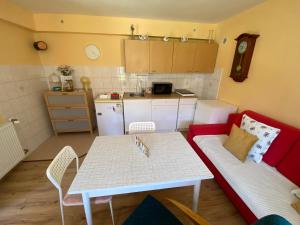 a living room with a red couch and a table at Apartment Anna in Šakvice