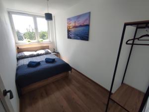 a small bedroom with a bed and a window at San Francisco Apartament, 6 osób, 49m2 in Rybnik