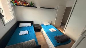a small room with two beds and a mirror at chambre 2 in Pau